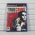 A PlayStation 2 game case for 'True Crime: Streets of LA' by Activision, featuring a red, black, and white cover with a portrait of a man holding a gun, photographed against a light gray paneled background.